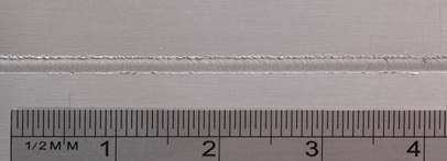 Figure7: Butt weld of 300&mu;m thick sheets of aluminium alloy - Detail of top surface of a 2.0 mm width weld line 